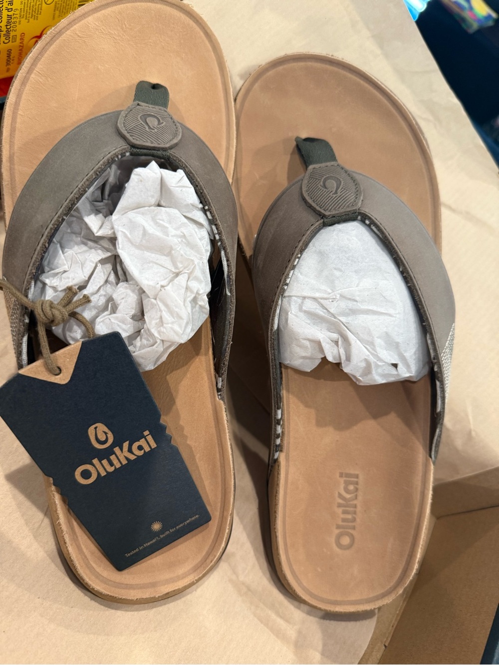 OluKai Tuahine Sandals in Hunter and Golden Sand